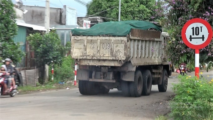 Chở đá vượt thùng xe, phủ bạt vải tạm bợ làm đá rơi xuống đường, gây nguy hiểm cho người tham gia giao thông bằng xe 2 bánh.