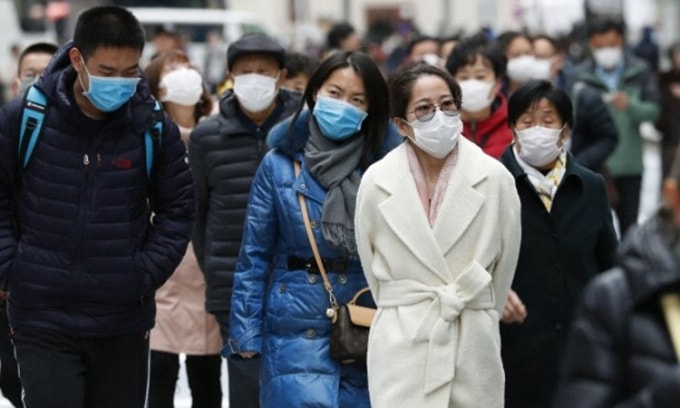 Người dân Nhật Bản đeo khẩu trang phòng chống nCoV trên đường phố Tokyo hôm 22/1. Ảnh: Kyodo News.