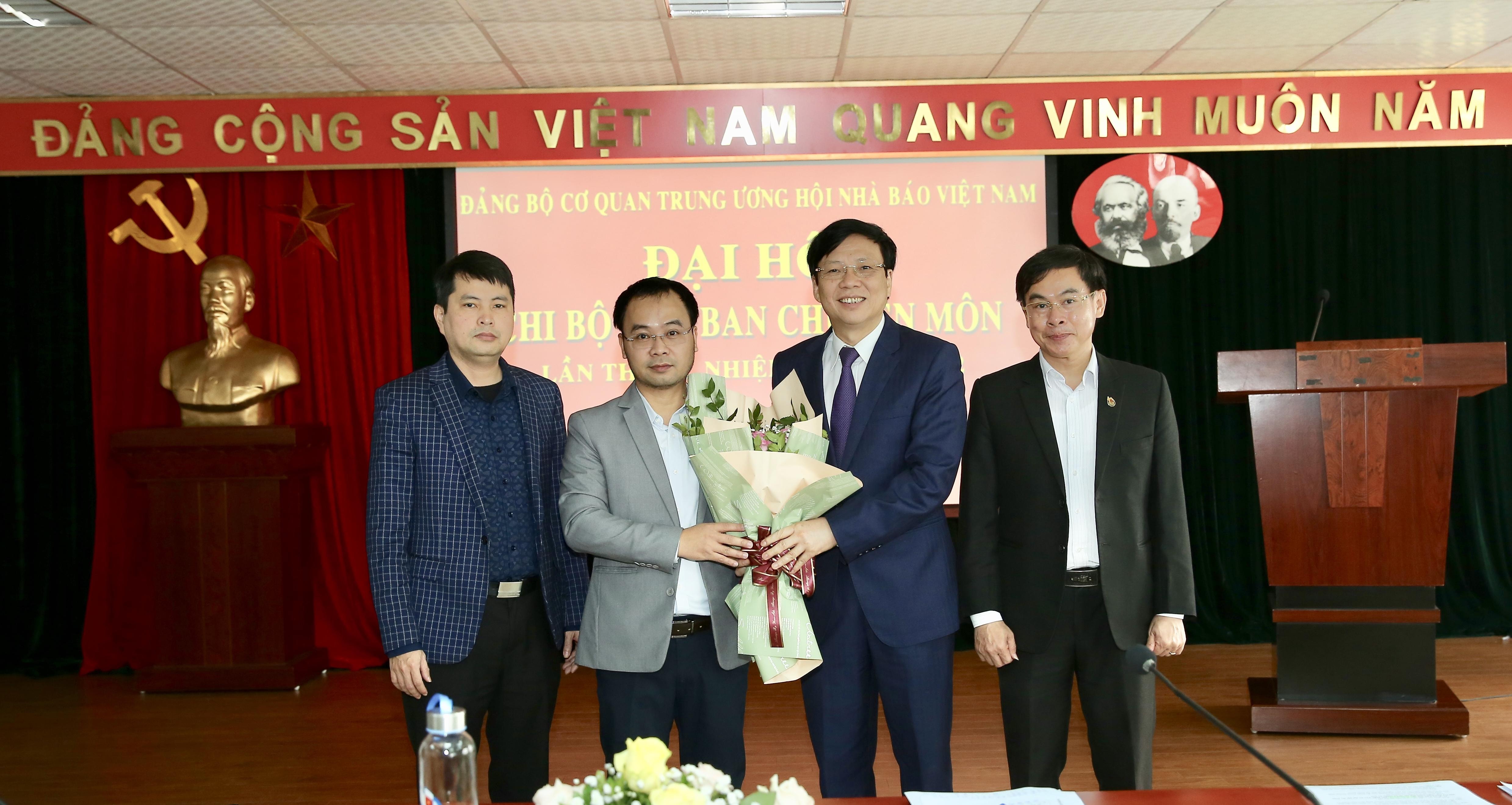 Đồng chí Hồ Quang Lợi, Phó Bí thư Đảng Đoàn Hội Nhà báo Việt Nam, Bí thư Đảng Ủy Cơ quan trung ương Hội Nhà báo Việt Nam tặng hoa chúc mừng Chi ủy nhiệm kỳ mới. Ảnh: Sơn Hải