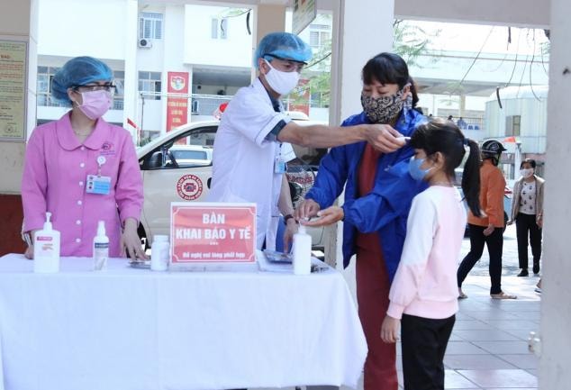 Thực hiện đo thân nhiệt cho người dân trước khi vào khám chuyên khoa chữa bệnh tại Bệnh viện Đa khoa tỉnh Quảng Ninh. Ảnh: Nguyễn Hoa.
