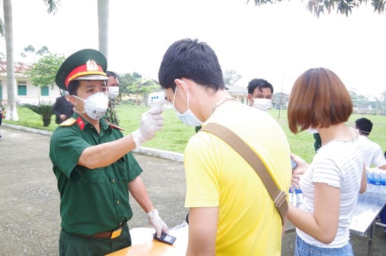 Lực lượng chức năng tiến hành kiểm tra thân nhiệt.