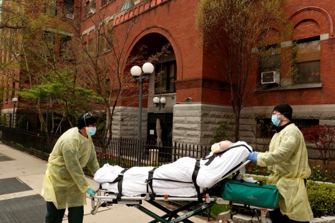Một bệnh nhân cao tuổi nhiễm Covid-19 được vận chuyển ra xe cứu thương ở New York, Mỹ. Ảnh: Reuters