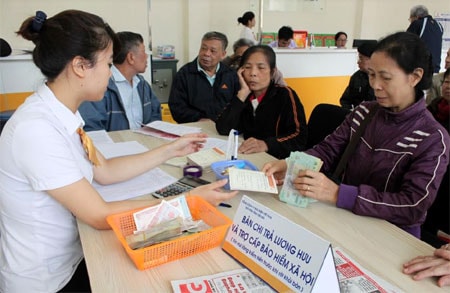 Người dân đến lĩnh lương hưu và trợ cấp BHXH tại điểm chi trả Bưu điện huyện Yên Bình, tỉnh Yên Bái. Ảnh: Báo Yên Bái