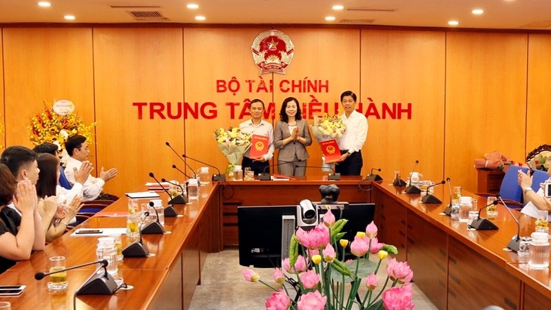 Thứ trưởng Vũ Thị Mai trao quyết định và tặng hoa chúc mừng ông Phạm Văn Hoành (bên phải) và ông Phạm Thu Phong (bên trái). Ảnh: DT