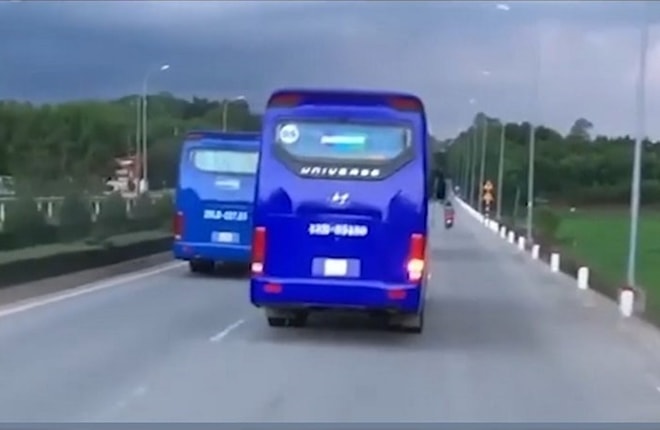 Xe chở công nhân liên tục cản đường xe chữa cháy. Ảnh cắt từ clip.