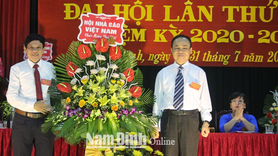 Đồng chí Trần Bá Dung, Uỷ viên Ban thường vụ, Trưởng ban nghiệp vụ Hội Nhà báo Việt Nam trao tặng đại hội lẵng hoa tươi thắm. Ảnh: Hồng Minh