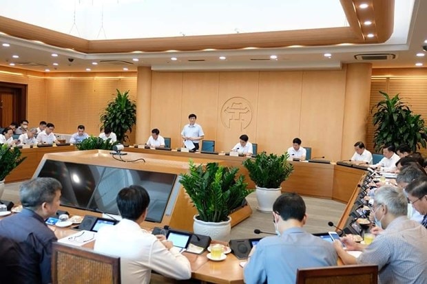 Bộ Y tế làm việc với Ủy ban Nhân dân thành phố Hà Nội. (Ảnh: PV/Vietnam+)