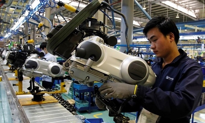 Ngày càng nhiều quốc gia tham gia vào chuỗi giá trị toàn cầu. Một công nhân Việt Nam trong dây chuyền sản xuất xe máy tại miền Bắc - Ảnh: Reuters