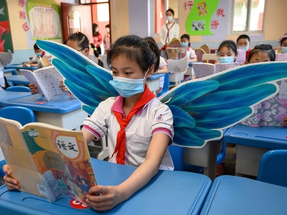 Một học sinh tiểu học đeo cánh để đảm bảo duy trì giãn cách xã hội ở Taiyuan. Ảnh: AFP