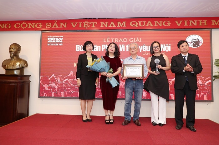 Phó Chủ tịch UBND TP Hà Nội Ngô Văn Quý (bên phải) cùng đại diện Ban tổ chức trao ''Giải thưởng lớn – Vì tình yêu Hà Nội'' cho đại diện gia đình nhạc sĩ Phú Quang. Ảnh: Linh Anh