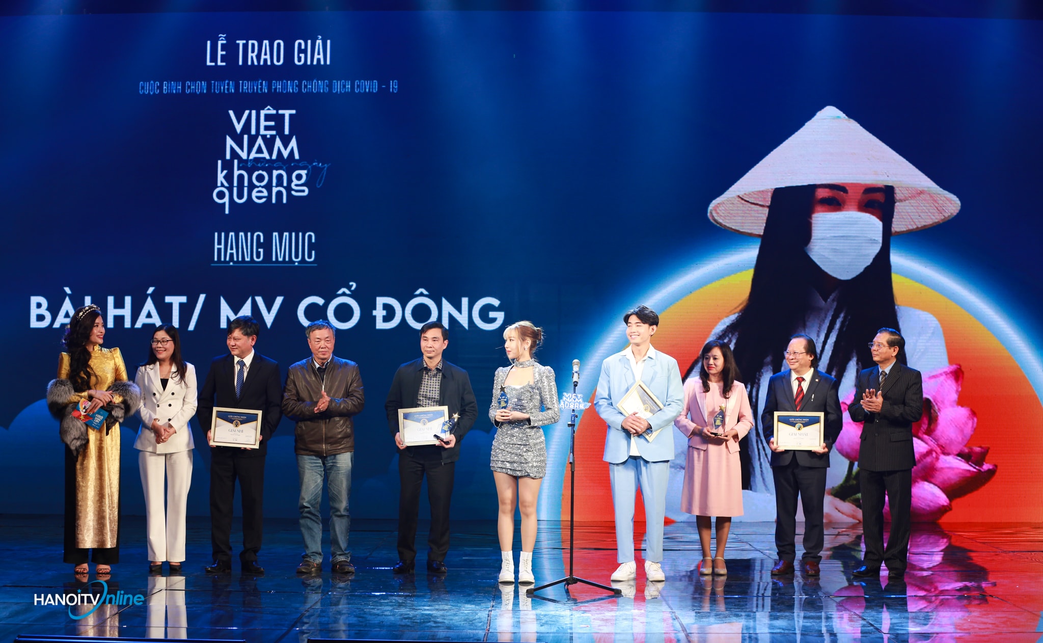 Ông Tô Quang Phán - Chủ tịch Hội Nhà báo TP Hà Nội - TGĐ, TBT Đài PT-TH Hà Nội trao giải hạng mục Bài hát/MV cổ động. Giải Nhất được trao cho tác phẩm 'Ghen Cô Vy - Vũ điệu rửa tay' của tác giả Khắc Hưng, biểu diễn Min và Quang Đăng.