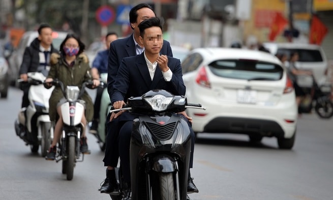 Nhiều người điều khiển xe mô tô, xe đạp điện không đội mũ bảo hiểm, chở quá số người quy định du xuân, chúc Tết tiềm ẩn nguy cơ cao gây mất an toàn giao thông. Ảnh minh họa
