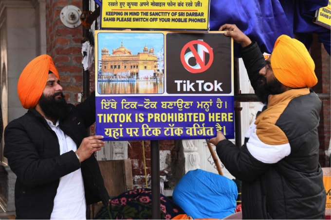 Các tình nguyện viên người Sikh treo một tấm biển ghi “TikTok bị cấm ở đây”, tại Đền Vàng ở Amritsar, Ấn Độ, vào hôm 10/2/2020. Ảnh: AFP.
