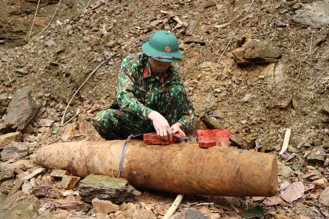 Lực lượng công binh thao tác đặt khối nổ để hủy nổ quả bom. Ảnh: dantri.com.vn