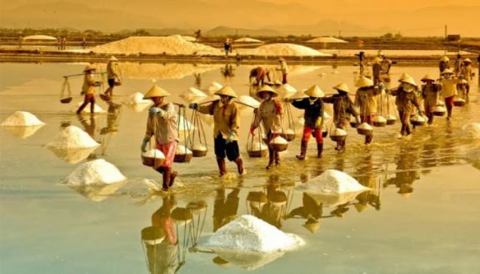 Những ngày đầu hạ, biển trong xanh, cánh đồng muối trắng tinh lấp lánh dưới ánh nắng, tạo nên khung cảnh hút hồn du khách.