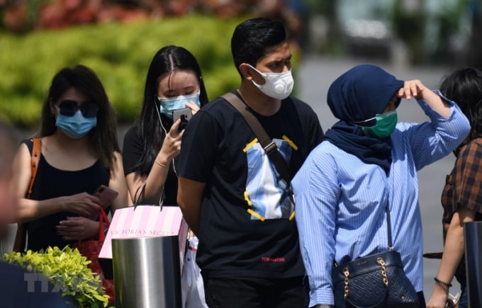 Người dân đeo khẩu trang phòng dịch COVID-2 tại Singapore . Ảnh: AFP