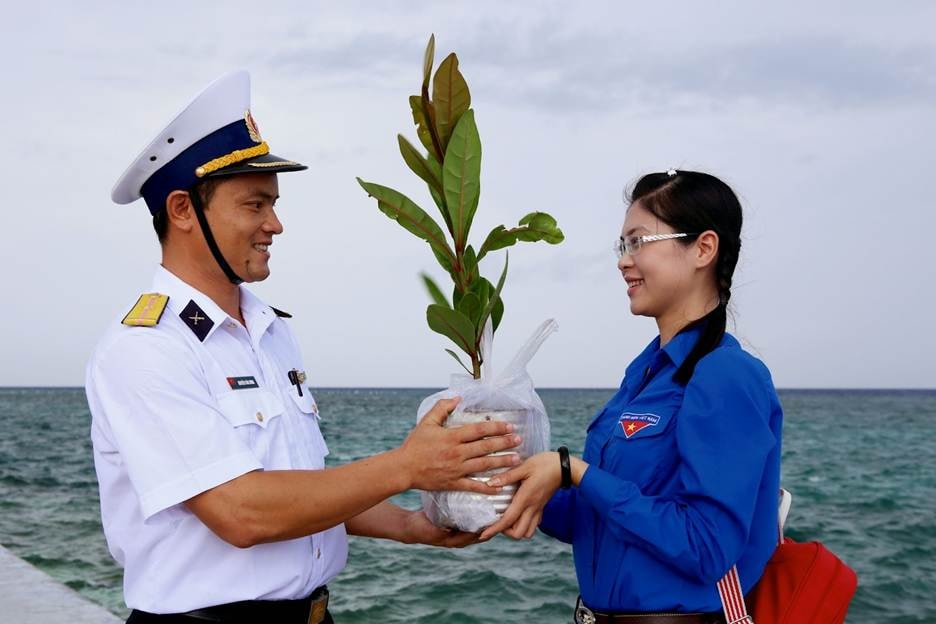 A person and person holding a plant AI-generated content may be incorrect.