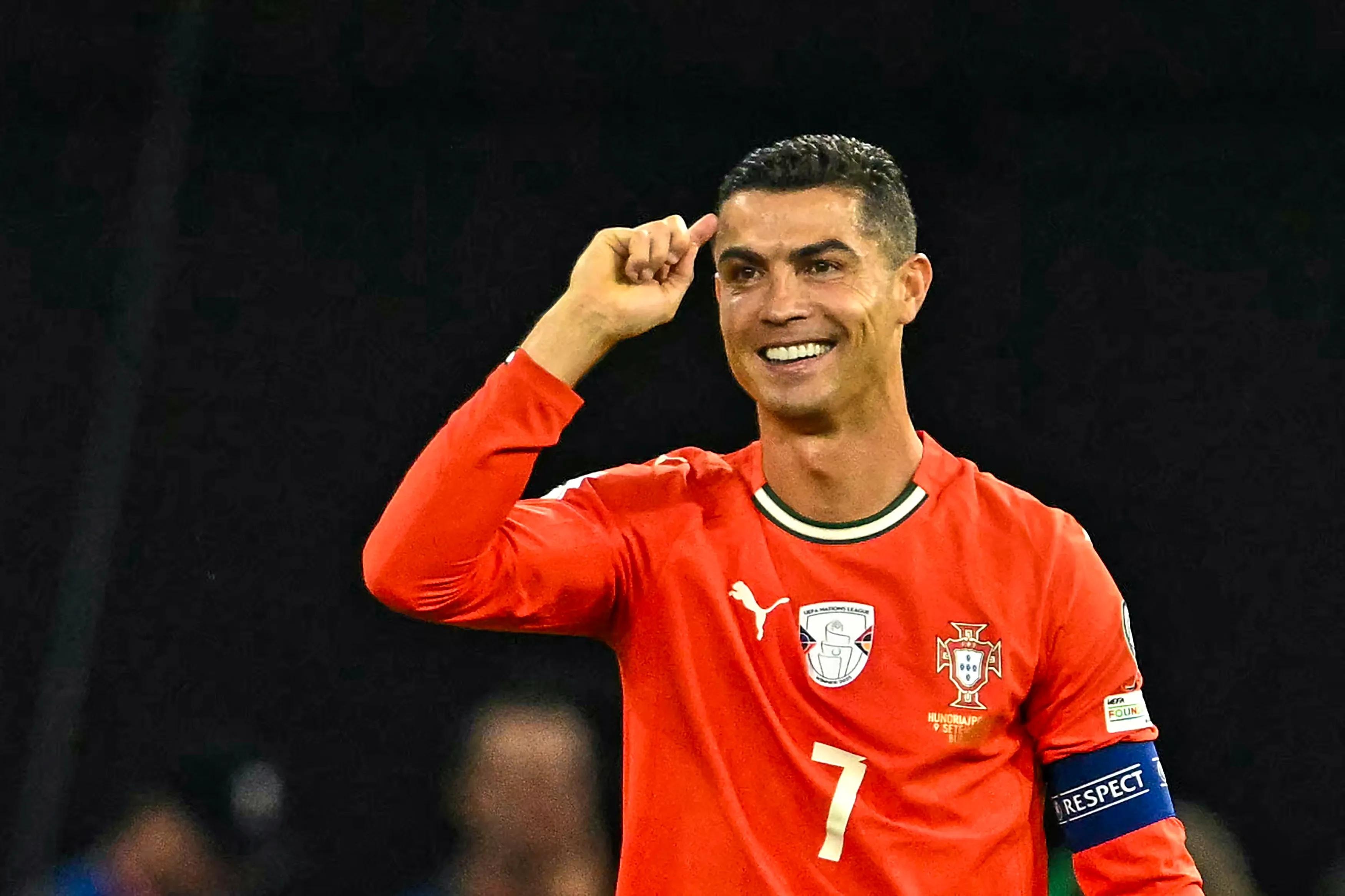 Portugal's forward #07 Cristiano Ronaldo (R) celebrates after scoring the 1-2 penalty goal as Hungary's midfielder #17 Callum Styles reacts during the 2026 World Cup qualifiers Europe zone group F football match between Hungary and Portugal on September 9, 2025 in Budapest, Hungary. (Photo by Attila KISBENEDEK / AFP) (Photo by ATTILA KISBENEDEK/AFP via Getty Images) 