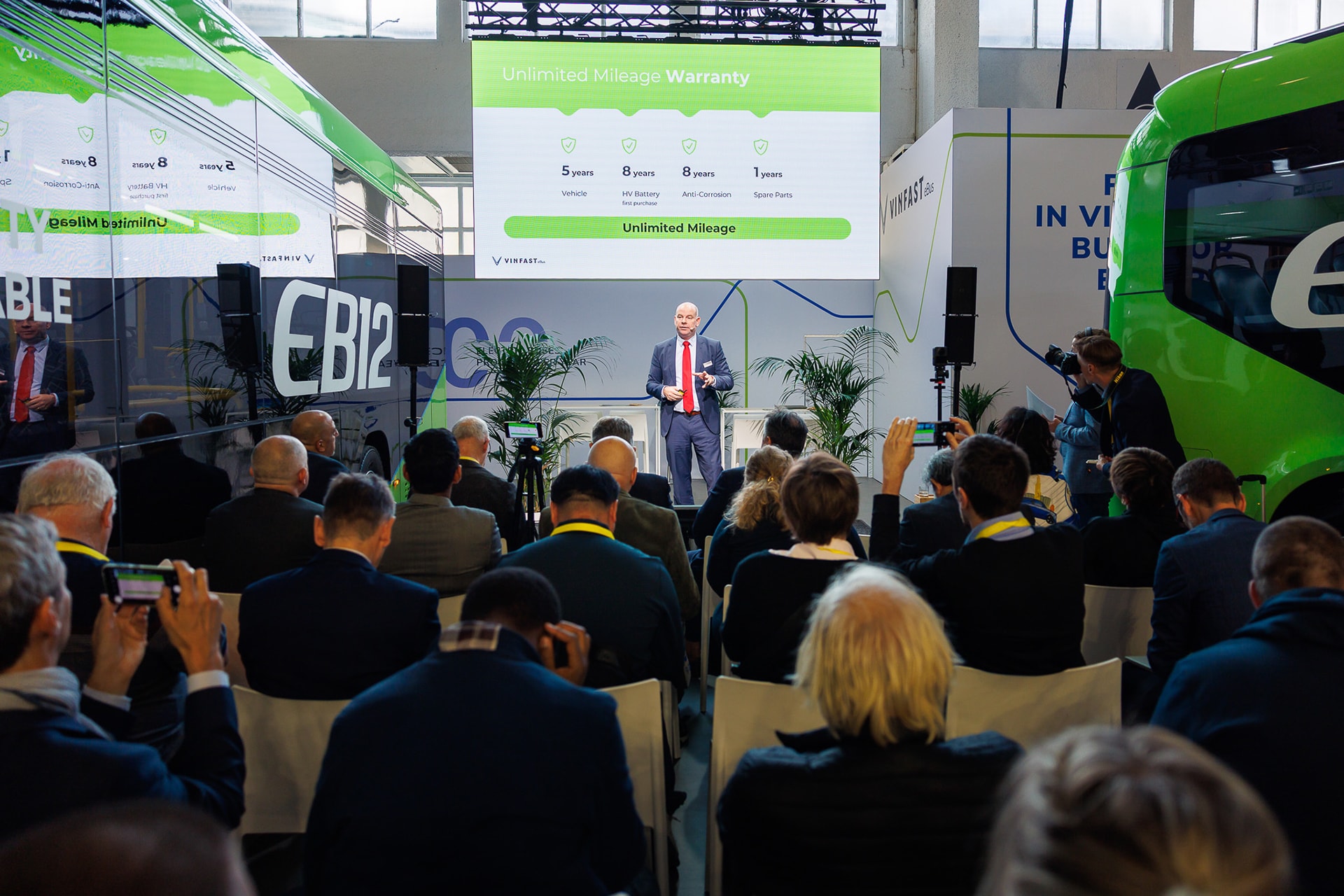 Đại diện VinFast giới thiệu 2 mẫu xe buýt điện tại triển lãm Busworld Europe 2025 - Ảnh: VinFast